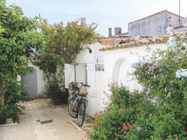 Vélo appuyé contre un mur dans une venelle à Ars-en-Ré