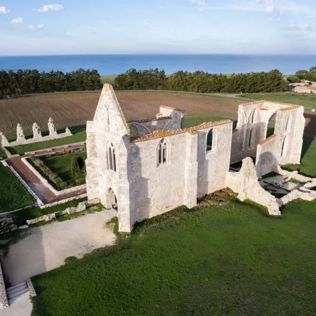 Vue aérienne de l'abbaye des Châteliers à La Flotte avec la mer en arrière-plan.