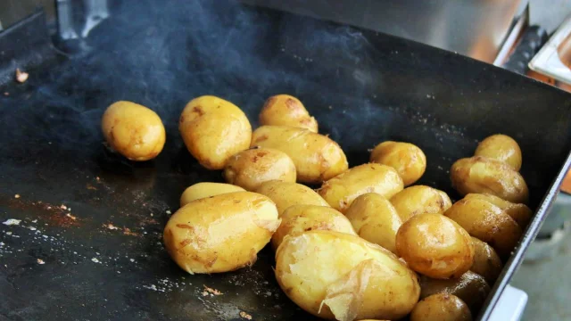 Pommes de terre en train de cuire sur une plaque chauffante.